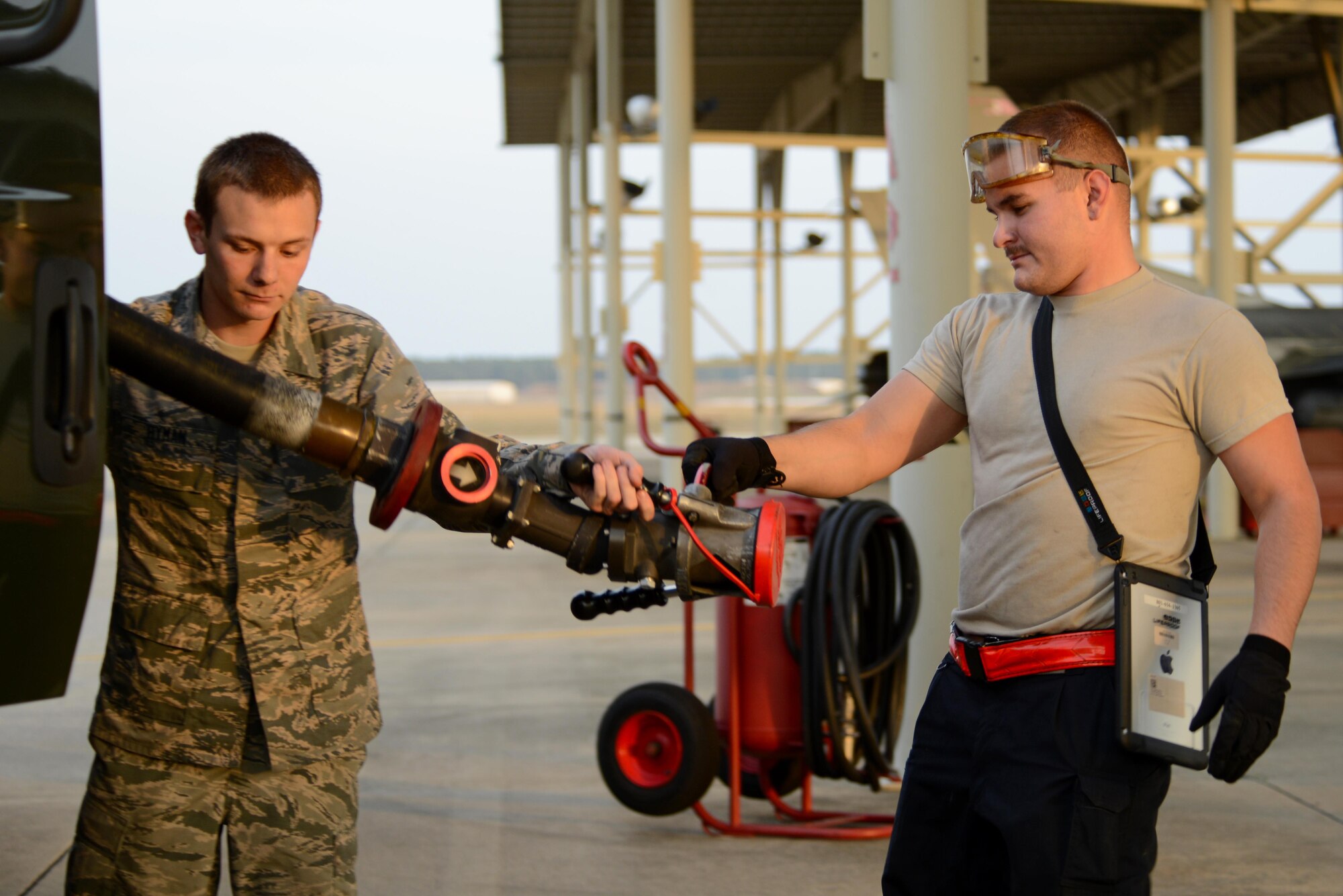 U.S. Air Force Airman 1st Class Zachary Rogers, 20th Aircraft Maintenance Squadron tactical aircraft maintainer, right, passes a fuel hose to Airman 1st Class Alec Hyman, 20th Logistics Readiness Squadron fuels distribution operator, left, at Shaw Air Force Base, S.C., Feb. 28, 2017. The hose allows Jet A fuel to flow from a R-11 refueling truck into F-16CM Fighting Falcons, filling an empty jet equipped with external tanks in approximately four minutes. (U.S. Air Force photo by Airman 1st Class Kathryn R.C. Reaves)