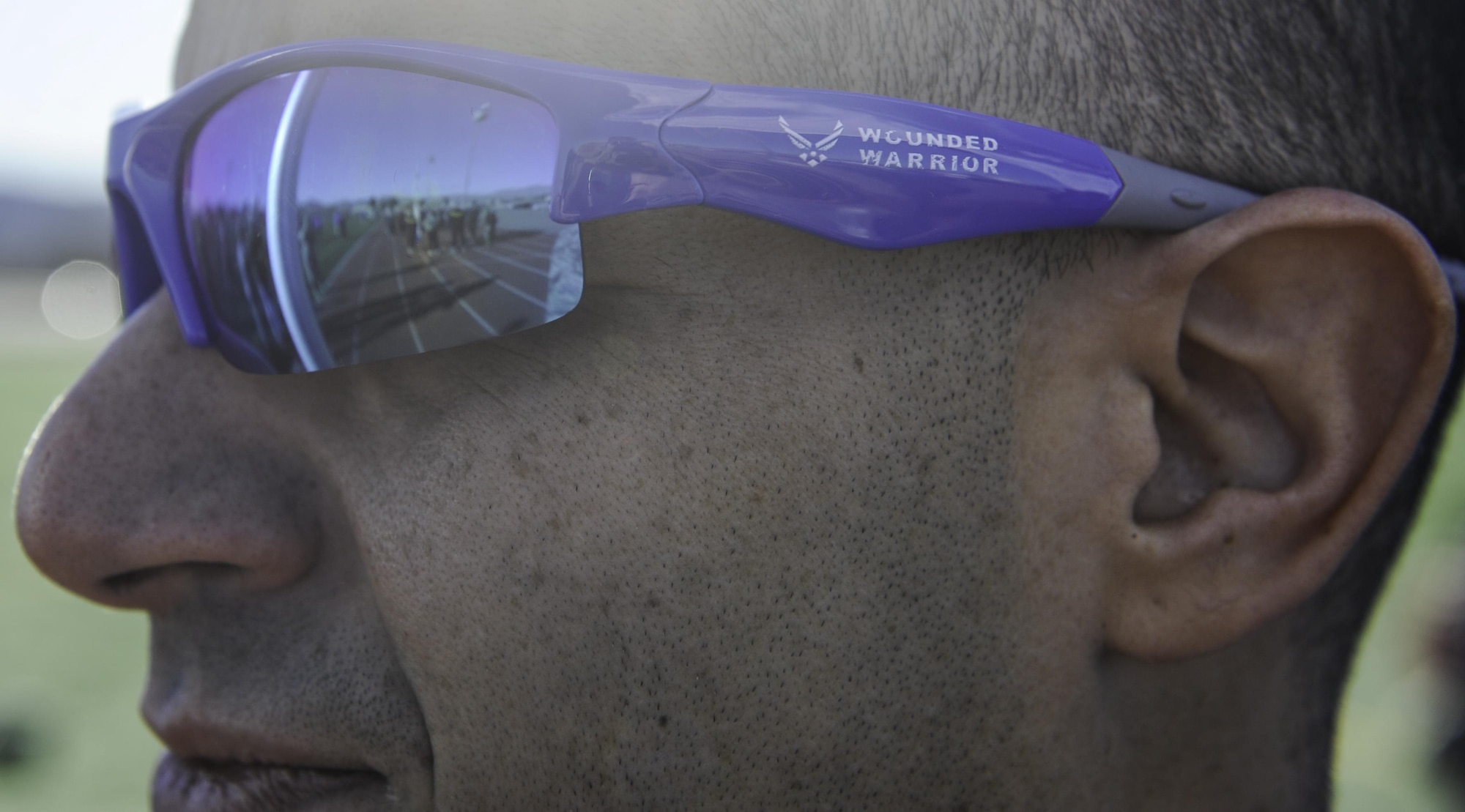 Retired U.S. Air Force Tech. Sgt. Freddie Rosario, a 2017 Air Force Warrior Game Trials competitor, wears Air Force wounded warrior sunglasses during the 2017 Air Force Wounded Warrior Trials opening ceremony on Nellis Air Force Base, Nev., Feb. 24, 2017. Service members are participating in adaptive athletic reconditioning for lasting effects on physical and emotional recovery. (U.S. Air Force photo by Airman 1st Class Kevin Tanenbaum/Released)