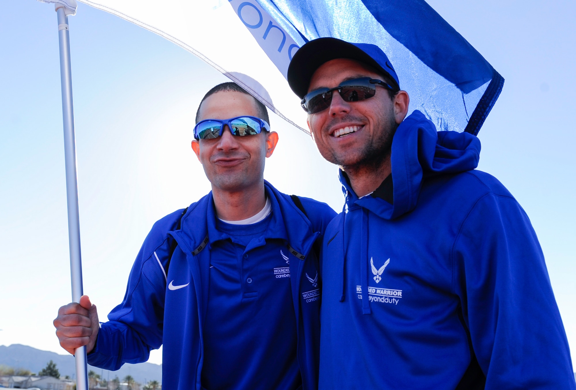 Air Force Wounded Warrior Trials competitors hold the wounded warrior flag before being announced at the opening ceremonies of the AFW2 on Nellis Air Force Base, Nev., Feb. 24, 2017. Wounded warriors are encouraged to come out and try adaptive sports as a way to begin a new chapter of their lives. (U.S. Air Force photo by Airman 1st Class Kevin Tanenbaum/Released)