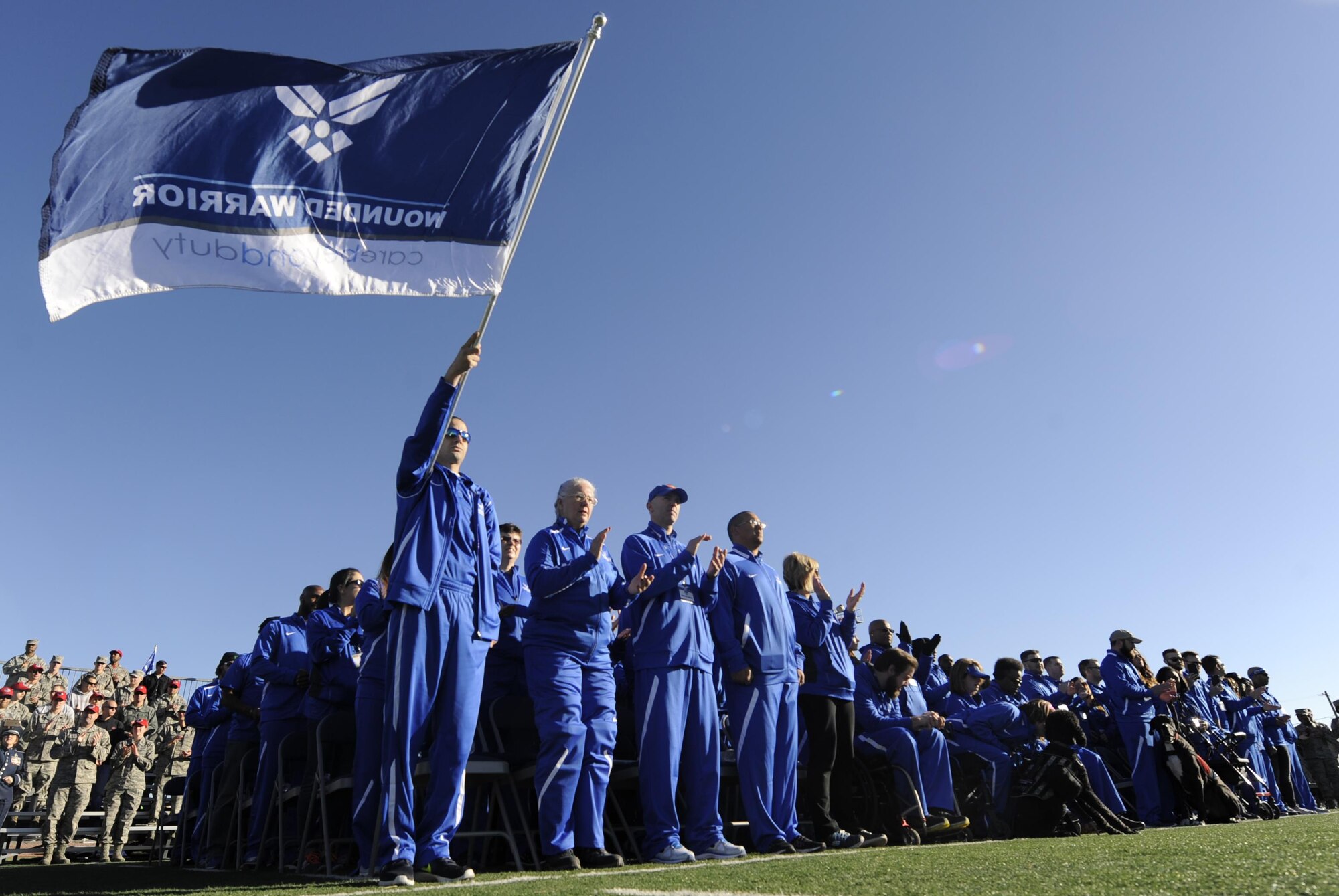 The competitors from the U.S. Air Force are announced at the 2017 Air Force Wounded Warrior Trials opening ceremony on Nellis Air Force Base, Nev., Feb. 24, 2017. The Trials are an adaptive sports event designed to promote the mental and physical well-being of seriously ill and injured military members and veterans. (U.S. Air Force photo by Airman 1st Class Kevin Tanenbaum/Released)