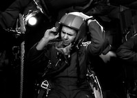 A 23rd Bomb Squadron aircrew member adjusts his helmet during egress training at Minot Air Force Base, N.D., Feb. 22, 2017. Aircrew trained in a simulated aircraft, where they learned how and when to safely exit the aircraft in the event of an emergency. (U.S. Air Force photo/Senior Airman J.T. Armstrong)