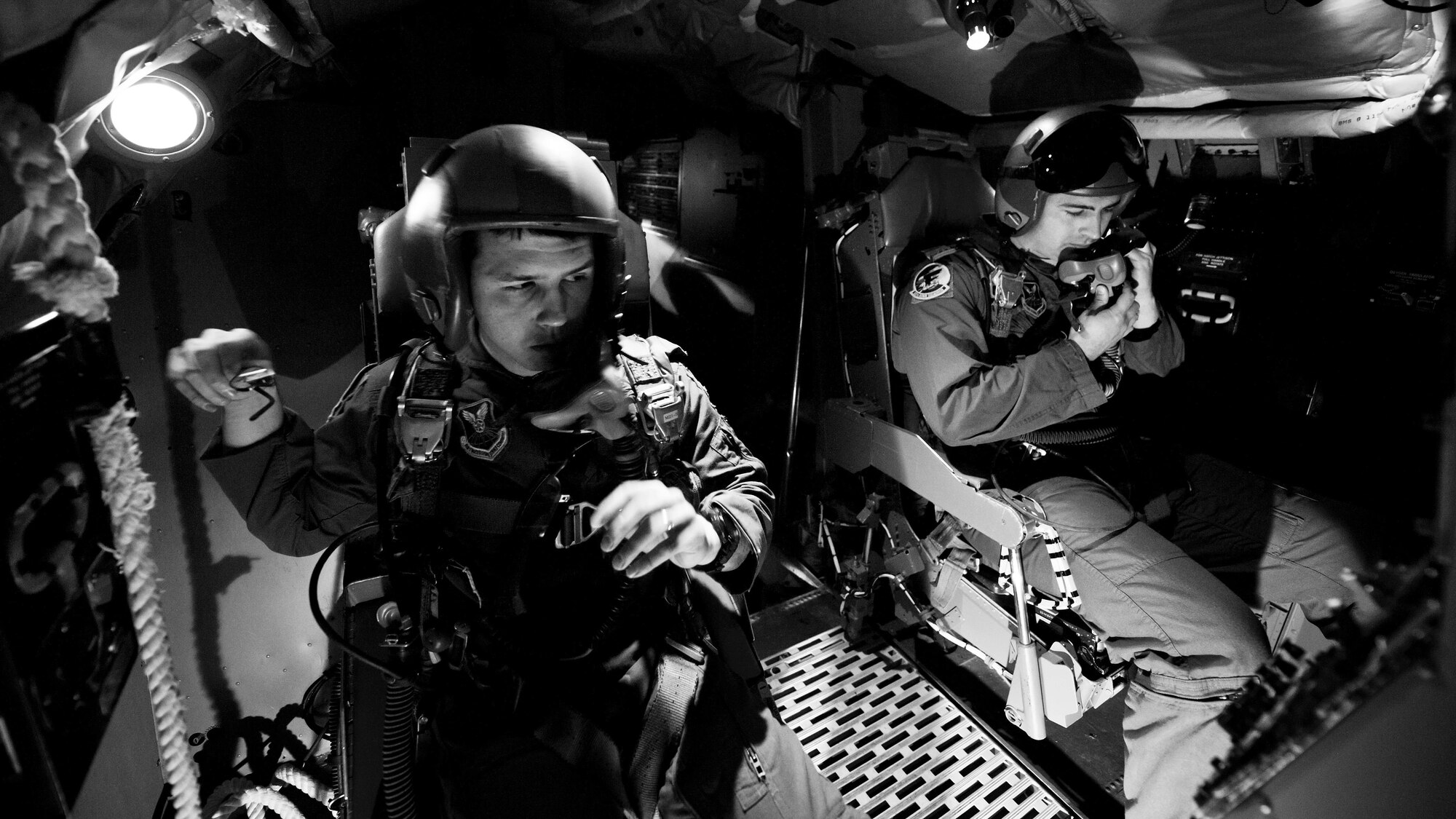 Aircrew members from the 23rd Bomb Squadron adjust their flight safety gear during egress training at Minot Air Force Base, N.D., Feb. 22, 2017. Thirteen 23 BS members trained in a simulated aircraft and learned how and when to safely exit the aircraft in the event of an emergency. (U.S. Air Force photo/Senior Airman J.T. Armstrong)