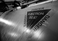 An ejection seat safety emblem decorates the side of an egress training simulator at Minot Air Force Base, N.D., Feb. 22, 2017. The egress simulator was constructed from the nose of a B-52G, similar to the B-52 Stratofortress. (U.S. Air Force photo/Senior Airman J.T. Armstrong)