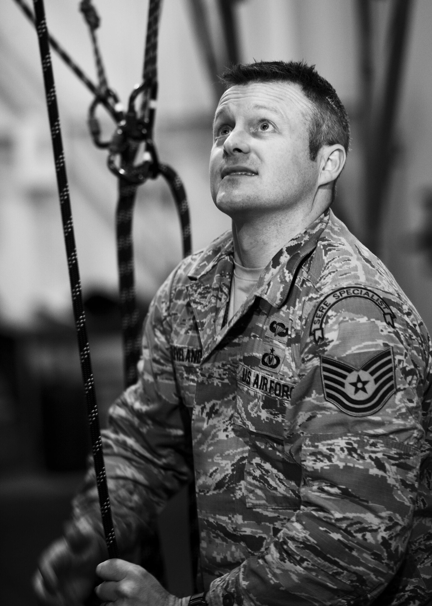 Tech. Sgt. Clifton Cleveland, 5th Operational Support Squadron survival, evasion, resistance and escape specialist, raises aircrew in simulated parachute harnesses via pulleys at Minot Air Force Base, N.D., Feb. 22, 2017. Egress and emergency parachute training teaches personnel how to safely exit an aircraft and return to the ground after an emergency. (U.S. Air Force photo/Senior Airman J.T. Armstrong)