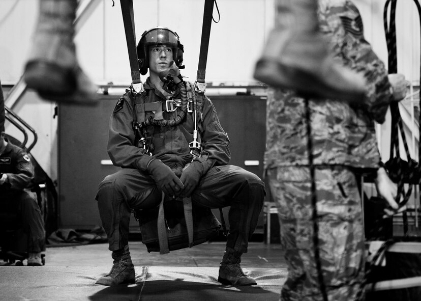A member of the 23rd Bomb Squadron hangs in a simulated parachute harness at Minot Air Force Base, N.D., Feb. 22, 2017. Egress and emergency parachute training teaches personnel how to safely exit the aircraft and return to the ground after an emergency. (U.S. Air Force photo/Senior Airman J.T. Armstrong)