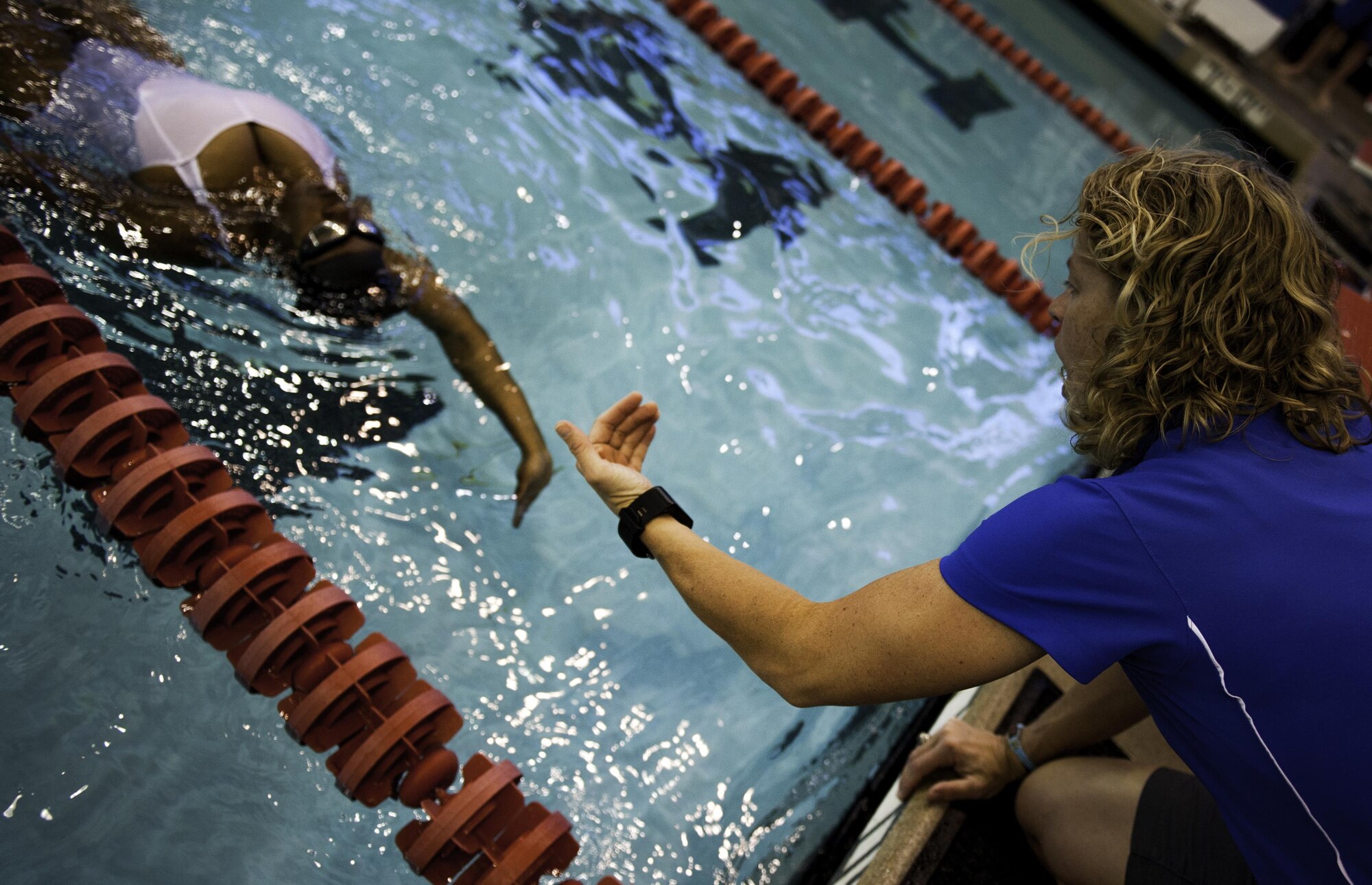 A coach cheers on a competitor during the women’s 50 meter backstroke during the Air Force Wounded Warrior Trials at the University of Nevada Las Vegas pool, Feb. 26, 2017. U.S. Air Force and Australian wounded warriors here to compete at the Air Force Trials Feb. 24 through March 2. (U.S. Air Force photo by Airman 1st Class Kevin Tanenbaum/Released)