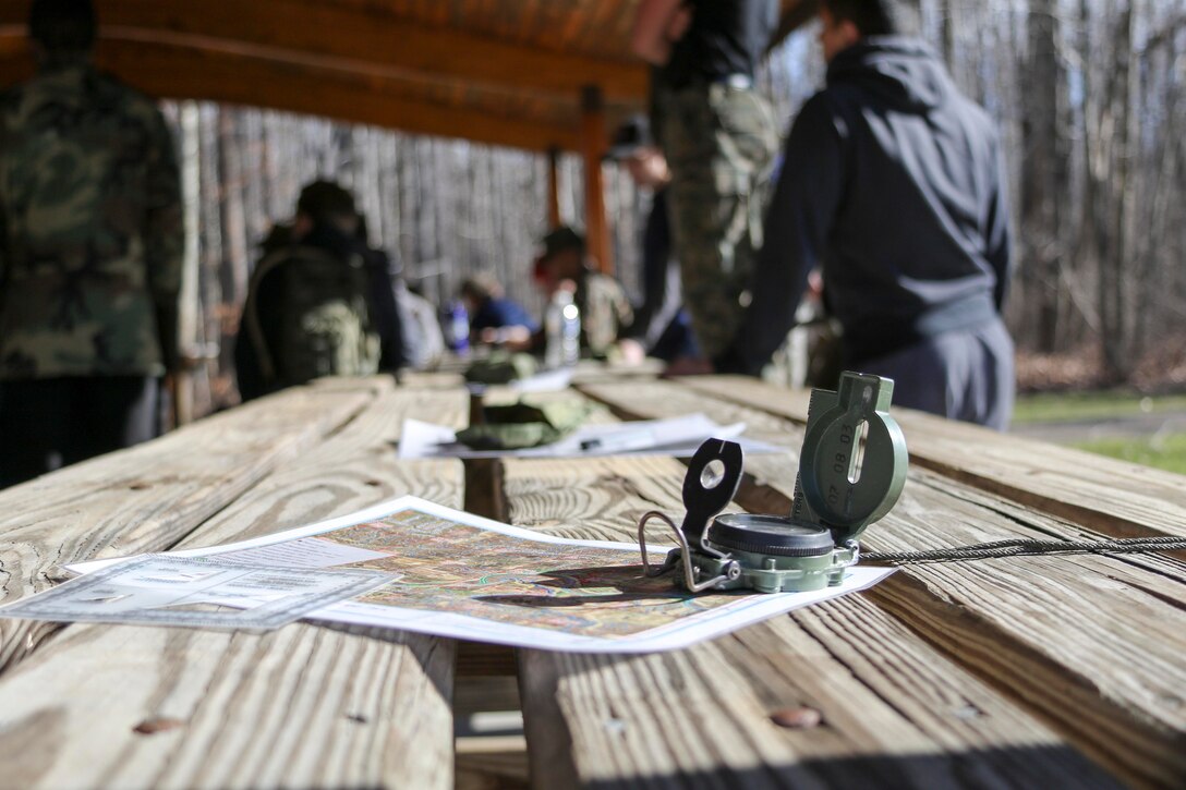 A protractor, a map, and a lensatic compass sit ready to be used by future Marines known as poolees of Marine Corps Recruiting Substation Mentor, Ohio, during a poolee function where the Marine recruiters taught a class on land navigation, February 18. The class gave the poolees an opportunity to practice a vital military skill.  The poolees had to locate five points in Hogback Ridge Park by applying the basic techniques and rules of land navigation. (U.S. Marine Corps photo by Sgt. Stephen D. Himes/Released)