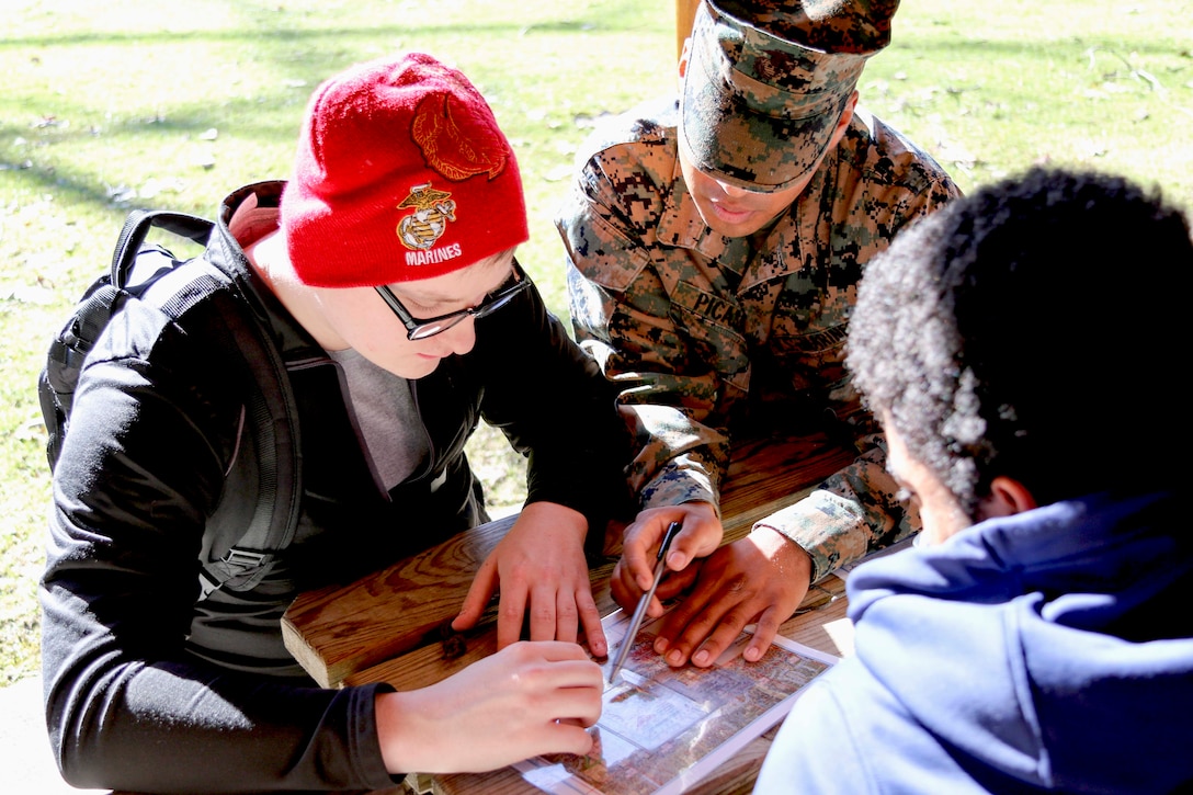 U.S. Marine Private Hector Picasso helps mentor future Marines known as poolees during a land navigation class at Hogback Ridge Park in Mentor, Ohio, February 18. Picasso is home on permissive recruiters’ assistance at Marine Corps Recruiting Substation Mentor. Land navigation is a crucial skill Marines need to know so they can find their way in the unfamiliar locations. Poolees will have to perform both day and night land navigation during recruit training and a successful completion of both training events is required to graduate. Picasso is from Ashtabula, Ohio, and graduated from Lakeside High School.(U.S. Marine Corps photo by Sgt. Stephen D. Himes/Released)