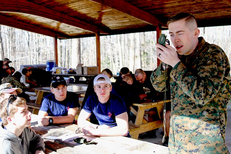 U.S. Marine Staff Sergeant Kevin Osborne performs a thumb-loop hold with a compass for a group of future Marines known as poolees from Marine Corps Recruiting Substation Mentor, Ohio, February 18 at Hogback Ridge Park. The poolees were taught how to conduct land navigation and then they put their skills to the test during a practical application period where they plotted points, determined an the azimuth, and located various points around the park. These poolees will be shipping to Marine Corps Recruit Training within the next 365 days.  (U.S. Marine Corps photo by Sgt. Stephen D. Himes/Released)