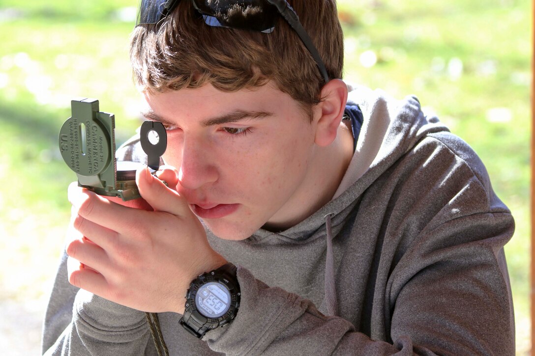 Future U.S. Marine Eric Nagy practices the thumb-loop hold and familiarizes himself with the compass before setting off to locate various points around Hogback Ridge Park February 18. The future Marines also known as poolees got a taste of an important skill which military members must learn in order to be better prepared for Marine Corps Recruit Training. Recruits at Marine Corps Recruit Depot Parris Island, South Carolina, are expected to pass two different land navigation training events: one during the day and one at night. Nagy is from Conneaut, Ohio, and will graduate from Conneaut High School in June.  (U.S. Marine Corps photo by Sgt. Stephen D. Himes/Released)