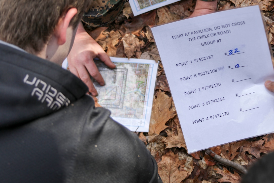 Future U.S. Marine also known as poolees plot their objective points on a map using a protractor during the practical application period of land navigation at Hogback Ridge Park February 18. These poolees were taught land navigation by their recruiters from Marine Corps Recruiting Substation Mentor, Ohio. Land navigation is an important part of the recruit training at Marine Corps Recruit Depot Parris Island, South Carolina and recruits are expected to pass two different land navigation training events. (U.S. Marine Corps photo by Sgt. Stephen D. Himes/Released)