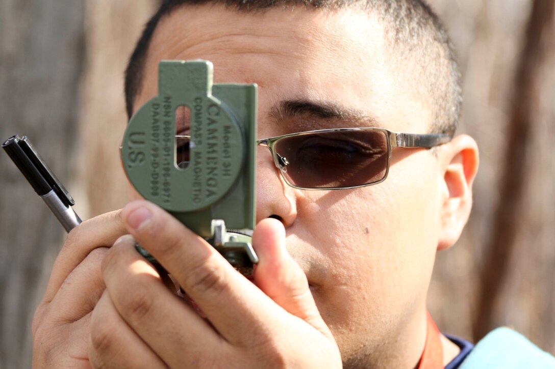 Future U.S. Marine Jose Mendez performs land navigation techniques before setting off to locate various points around Hogback Ridge Park February 18. The future Marines also known as poolees got a taste of an important military skill in order to be better prepared for Marine Corps Recruit Training. Recruits at Marine Corps Recruit Depot Parris Island, South Carolina, are expected to pass two different land navigation training events: one during the day and one at night. Mendez is from Painesville, Ohio, and will graduate from Riverside High School. (U.S. Marine Corps photo by Sgt. Stephen D. Himes/Released)