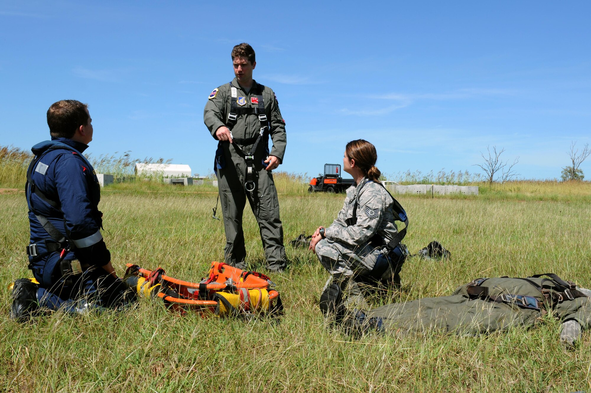 Rescue Crewman Kurt Pride, Royal Australian Air Force Base Tindal helicopter unit member, U.S. Air Force Capt. Paul Ward, 90th Fighter Squadron Flight Doctor, and Tech. Sgt. Layla Dispense, 90th FS Independent Duty Medical Technician, prepare a dummy for transport on a stretcher during helicopter rescue training at RAAF Base Tindal, Feb. 28, 2017. Ward and Dispense are deployed to Australia as part of the Enhanced Air Cooperation, a joint training and exercise initiative under the Force Posture Agreement between the U.S. and Australian governments. (U.S. Air Force photo by Staff Sgt. Alexander Martinez)
