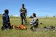Rescue Crewman Kurt Pride, Royal Australian Air Force Base Tindal helicopter unit member, U.S. Air Force Capt. Paul Ward, 90th Fighter Squadron Flight Doctor, and Tech. Sgt. Layla Dispense, 90th FS Independent Duty Medical Technician, prepare a dummy for transport on a stretcher during helicopter rescue training at RAAF Base Tindal, Feb. 28, 2017. Ward and Dispense are deployed to Australia as part of the Enhanced Air Cooperation, a joint training and exercise initiative under the Force Posture Agreement between the U.S. and Australian governments. (U.S. Air Force photo by Staff Sgt. Alexander Martinez)