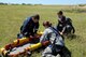 Rescue Crewman Kurt Pride, Royal Australian Air Force Base Tindal helicopter unit member, U.S. Air Force Capt. Paul Ward, 90th Fighter Squadron Flight Doctor, and Tech. Sgt. Layla Dispense, 90th FS Independent Duty Medical Technician, prepare a dummy for transport on a stretcher during helicopter rescue training at RAAF Base Tindal, Feb. 28, 2017. Ward and Dispense are deployed to Australia as part of the Enhanced Air Cooperation, a joint training and exercise initiative under the Force Posture Agreement between the U.S. and Australian governments. (U.S. Air Force photo by Staff Sgt. Alexander Martinez)