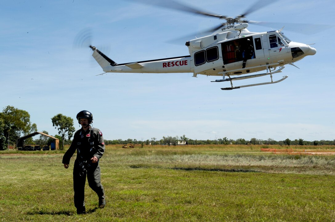 U.S. Air Force Capt. Paul Ward, 90th Fighter Squadron Flight Doctor, departs a helicopter during helicopter rescue training at RAAF Base Tindal, Feb. 28, 2017. Ward is deployed to Australia as part of the Enhanced Air Cooperation, a joint training and exercise initiative under the Force Posture Agreement between the U.S. and Australian governments. (U.S. Air Force photo by Staff Sgt. Alexander Martinez)