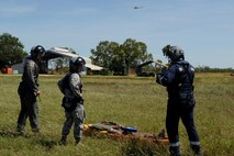 Rescue Crewman Kurt Pride (right), Royal Australian Air Force Base Tindal helicopter unit member, U.S. Air Force Capt. Paul Ward, 90th Fighter Squadron Flight Doctor, and Tech. Sgt. Layla Dispense, 90th FS Independent Duty Medical Technician, prepare a dummy for transport on a stretcher during helicopter rescue training at RAAF Base Tindal, Feb. 28, 2017. Ward and Dispense are deployed to Australia as part of the Enhanced Air Cooperation, a joint training and exercise initiative under the Force Posture Agreement between the U.S. and Australian governments. (U.S. Air Force photo by Staff Sgt. Alexander Martinez)