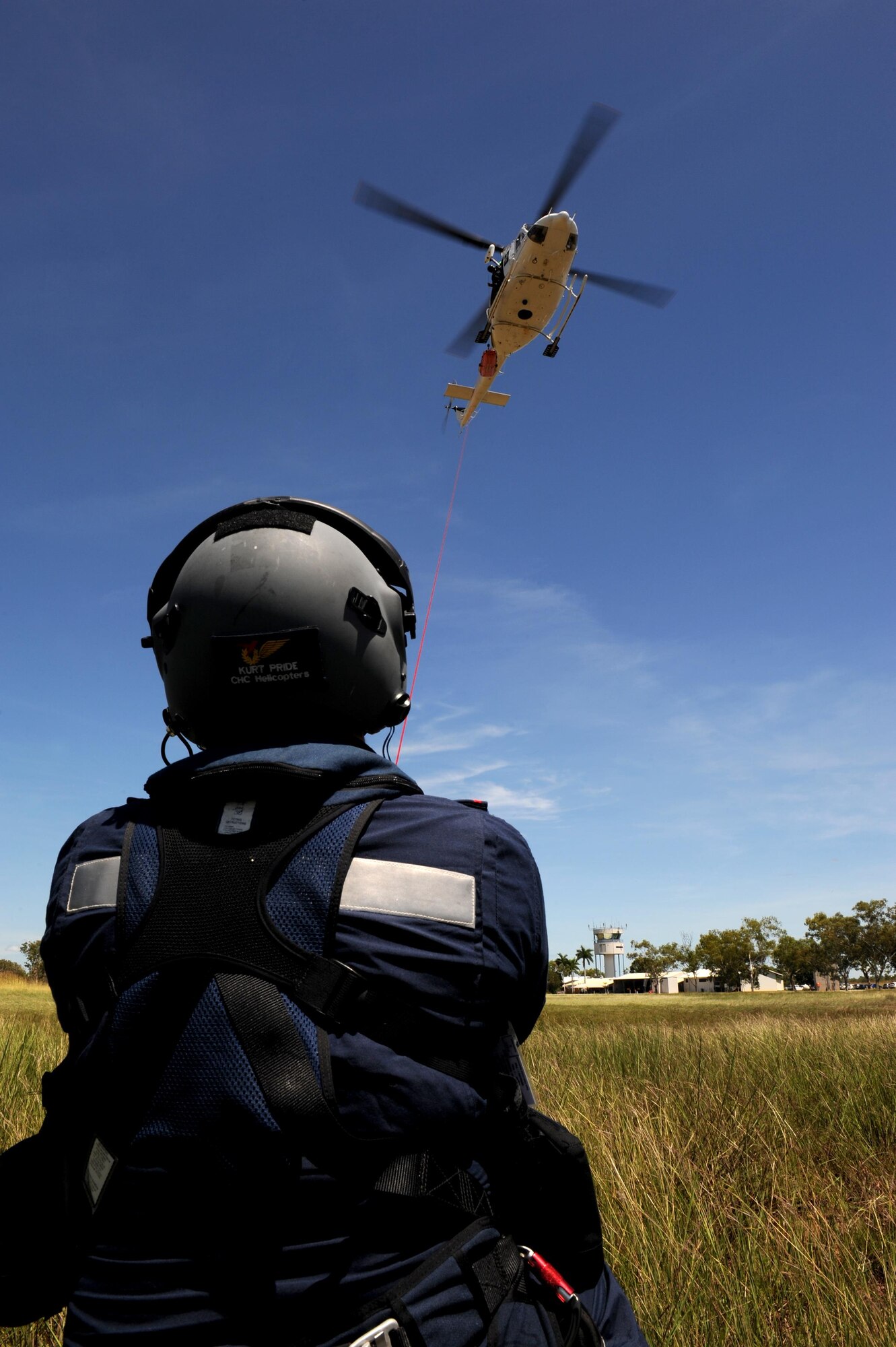 Rescue Crewman Kurt Pride, Royal Australian Air Force Base Tindal helicopter unit member, assists the winch raising of a stretcher during helicopter rescue training at RAAF Base Tindal, Feb. 28, 2017. Particpating in the training was two 90th Fighter Squadron medical personnel who are deployed to Australia as part of the Enhanced Air Cooperation, a joint training and exercise initiative under the Force Posture Agreement between the U.S. and Australian governments. (U.S. Air Force photo by Staff Sgt. Alexander Martinez)