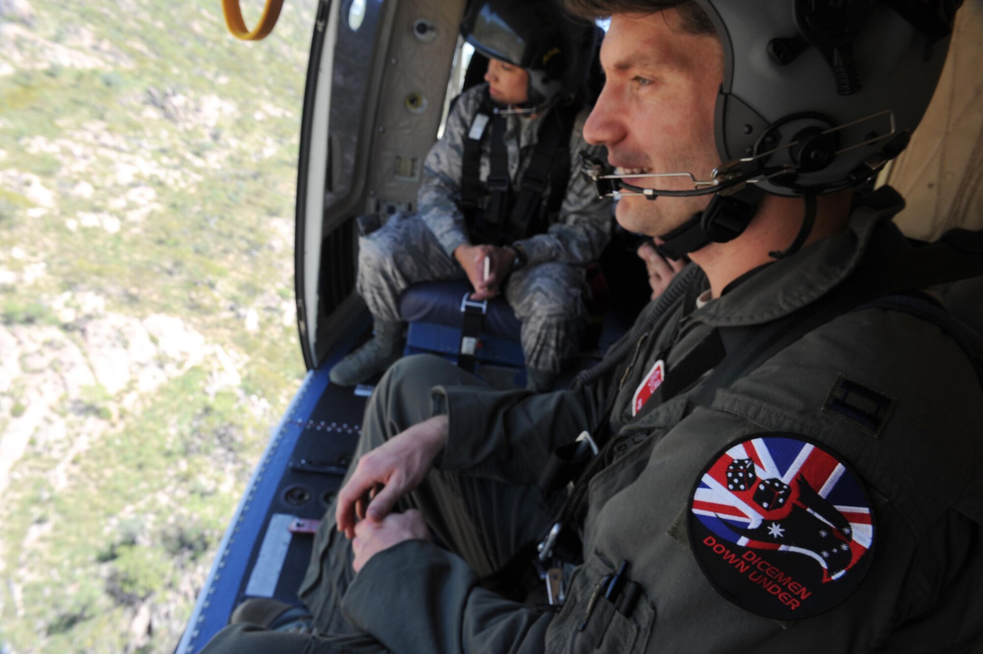 U.S. Air Force Capt. Paul Ward, 90th Fighter Squadron Flight Doctor, and Tech. Sgt. Layla Dispense, 90th FS Independent Duty Medical Technician, get a bird's-eye view of the Northern Territory landscape during helicopter rescue training at RAAF Base Tindal, Feb. 28, 2017. Ward and Dispense are deployed to Australia as part of the Enhanced Air Cooperation, a joint training and exercise initiative under the Force Posture Agreement between the U.S. and Australian governments. (U.S. Air Force photo by Staff Sgt. Alexander Martinez)
