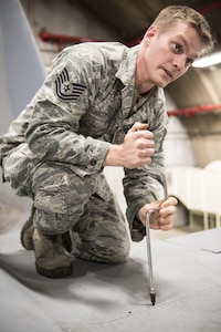 U.S. Air Force Tech. Sgt. Michael Hust, 44th Aircraft Maintenance Unit lead electrical and environmental specialist, demonstrates how to remove a panel from an F-15A Eagle Feb. 28, 2017, at Kadena Air Base, Japan. Hust helps instruct new electrical and environmental maintainers for the 18th Maintenance Training Flight’s new ENE core tasks course.