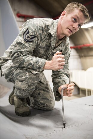 U.S. Air Force Tech. Sgt. Michael Hust, 44th Aircraft Maintenance Unit lead electrical and environmental specialist, demonstrates how to remove a panel from an F-15A Eagle Feb. 28, 2017, at Kadena Air Base, Japan. Hust helps instruct new electrical and environmental maintainers for the 18th Maintenance Training Flight’s new ENE core tasks course.