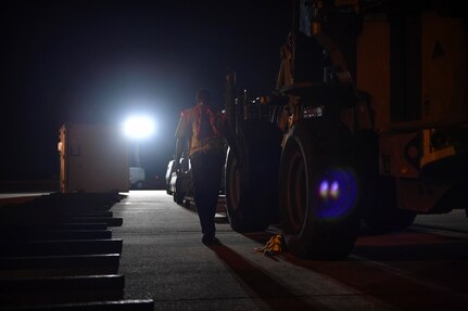 A member of the 437th Aerial Port Squadron inspects cargo on the flightline during Exercise Bonny Jack here, March 1, 2017. Exercise Bonny Jack was a two-day mobility exercise testing the cargo deployment capabilities of the 437th Airlift Wing. Members of Team Charleston conducted 24-hour operations for the exercise to move 95 short tons of cargo.