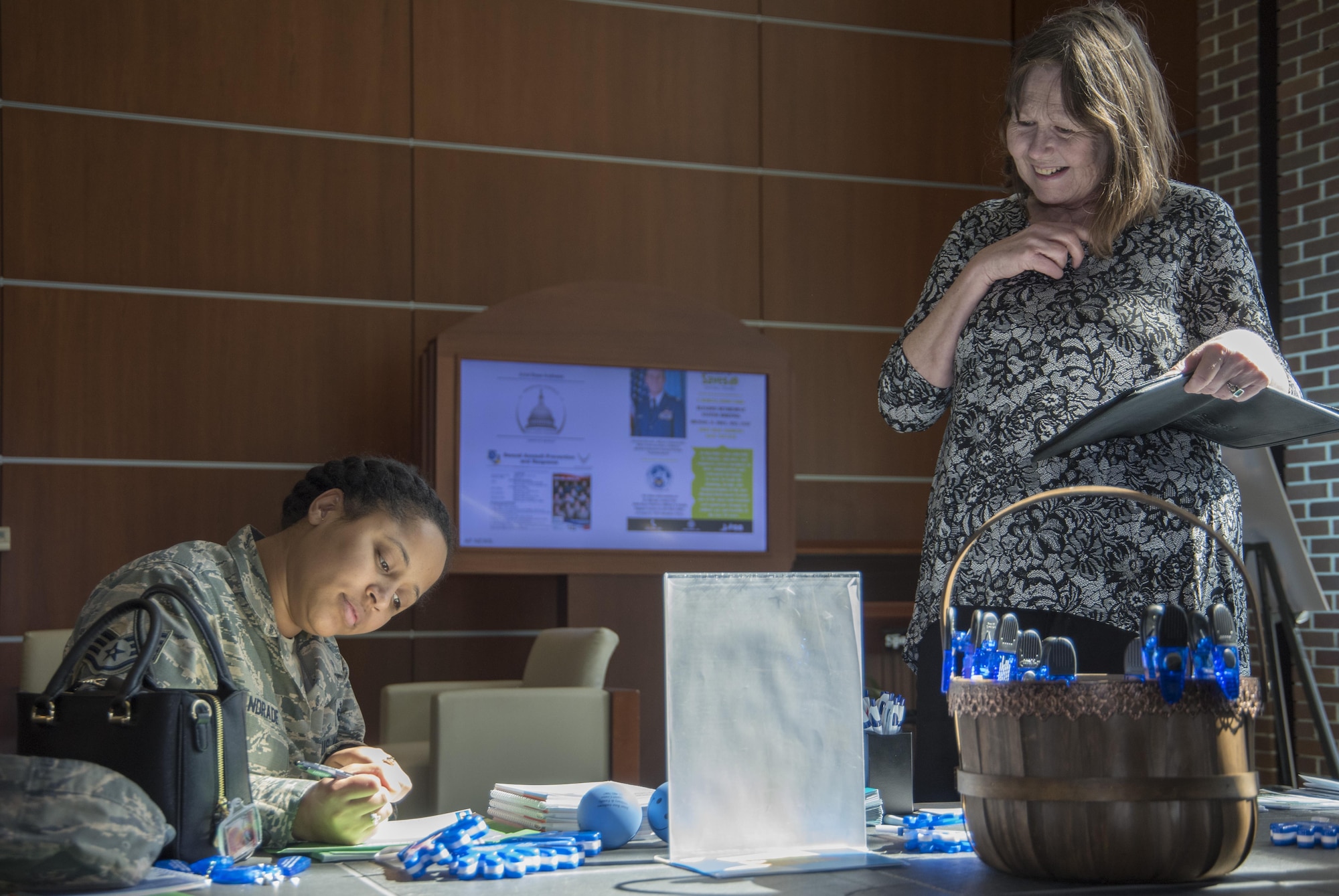 Sharon Moore, right, 11th Force Support Squadron community readiness consultant, advises Staff Sgt. Adande Andrade, left, Medical Law Branch paralegal, on how to make a Savings Pledge during Military Saves Week at Joint Base Andrews, Md., March 2, 2017. During the week, members and their families were encouraged to make a pledge, a personal commitment to individuals to save money for different purposes, which were entered into a drawing for a chance to win one of three $100 gift cards. (U.S. Air Force photo by Senior Airman Jordyn Fetter)