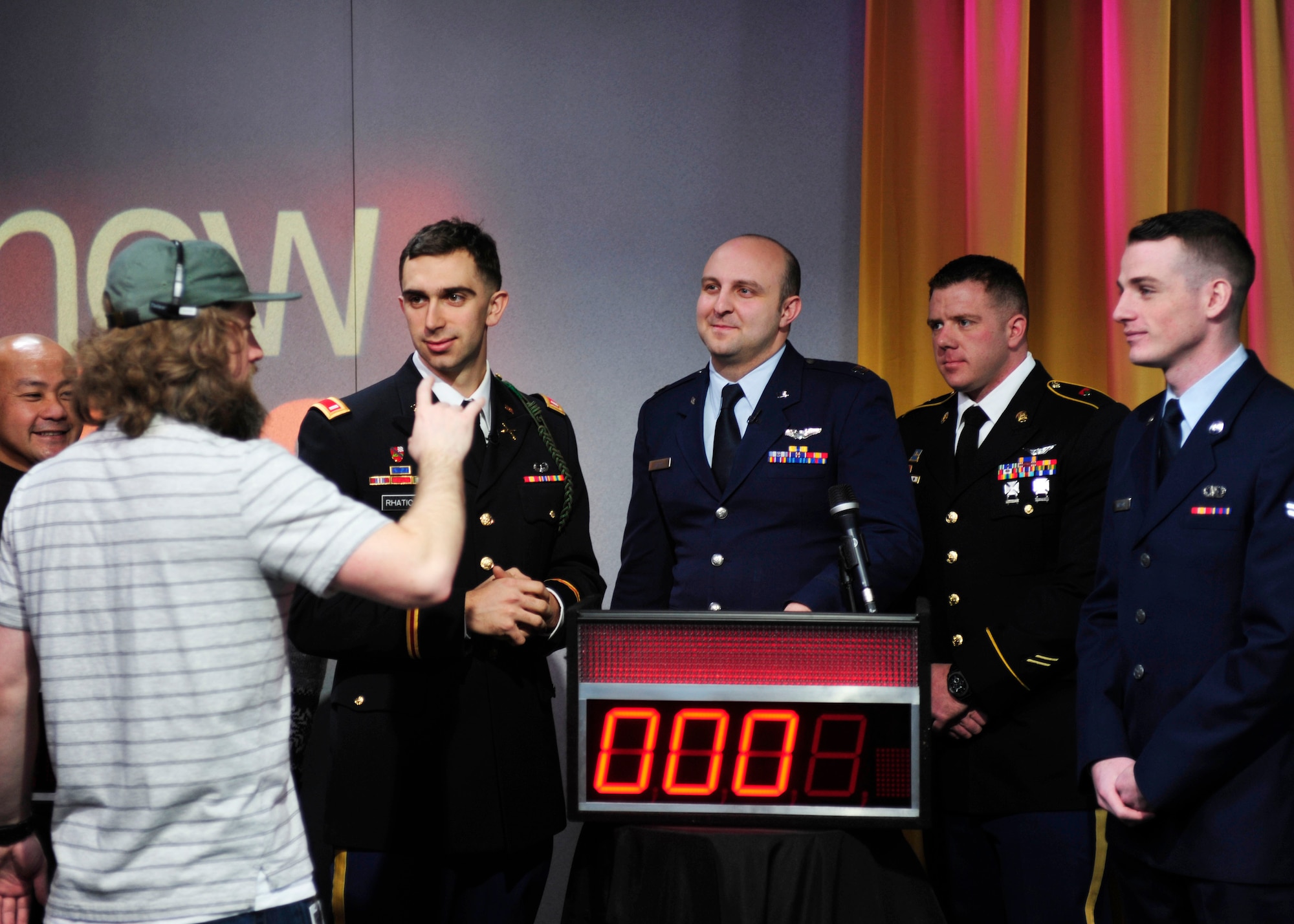 U.S. Army Soldiers and U.S. Air Force Airmen from Joint Base Lewis-McChord, Wash., listen as a King 5 “New Day” show camera operator explains rules of play prior to kicking off a round of on-air trivia, Feb. 28, 2017 in Seattle, Wash. During the game, servicemembers competed against a group of four civilians, and ultimately walked away with a win under their belts. (U.S. Air Force photo/Staff Sgt. Whitney Amstutz)