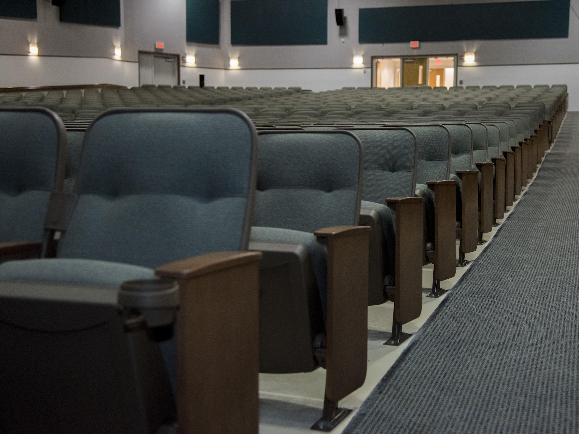 Seats line the inside of the base theater at Joint Base Andrews, Md., March 3, 2017. The theater seating was newly renovated in January and can accommodate roughly 1,000 audience members at a time. A free movie screening of “Kong: Skull Island” for Department of Defense cardholders is scheduled during the base theater grand opening, March 4, 2017, at 7 p.m.  (U.S. Air Force photo by Airman 1st Class Valentina Lopez)