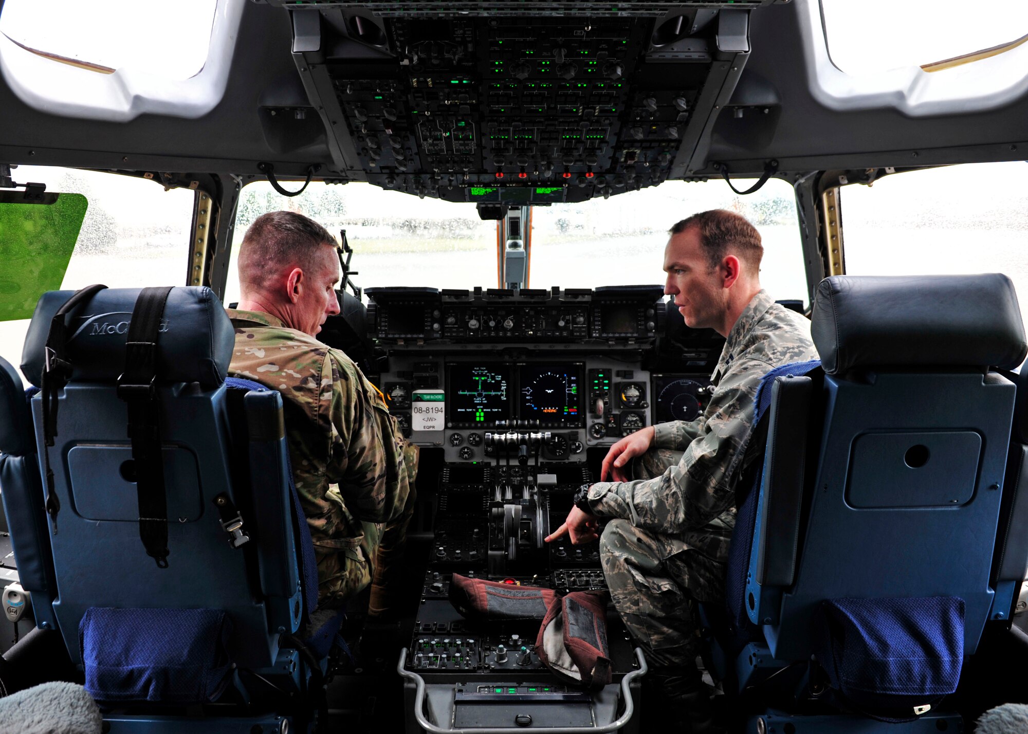 U.S. Army Maj. Gen. Gary Volesky (left), incoming I Corps commanding general, talks with U.S. Air Force Capt. Trevor Evans, 62nd Airlift Wing Protocol officer, on the flight deck of a C-17 during an orientation tour, March 2, 2017 at Joint Base Lewis-McChord. The tour was designed to better acquaint Volesky with Air Force capabilities and mission sets prior to his assumption of command. (U.S. Air Force photo/Staff Sgt. Whitney Amstutz)