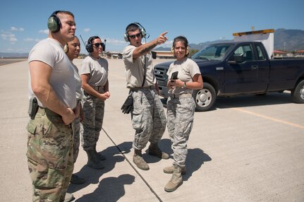 Staff Sgt. Sean Sullivan, 612th Air Base Squadron crew chief, shows participants of a "Crew Chief For a Day" program where an incoming heavy aircraft will be taxiing. The program aims to get other servicemembers from JTF-Bravo to come out to the airfield and experience a day in the life of a U.S. Air Force crew chief.