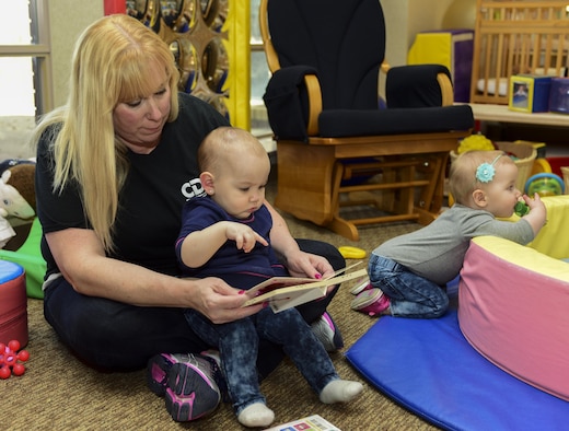 Heidi Sowers, a child program technician assigned to the 28th Force Support Squadron Child Development Center at Ellsworth Air Force Base, S.D., reads to children inside a classroom March 3, 2017. Sowers was one of 50 childcare center educators in the U.S. who won the Terry Lynn Lokoff Award, a national-level award promoting teachers’ projects to better improve teaching environments for children. (U.S. Air Force photo by Airman 1st Class Randahl J. Jenson) 