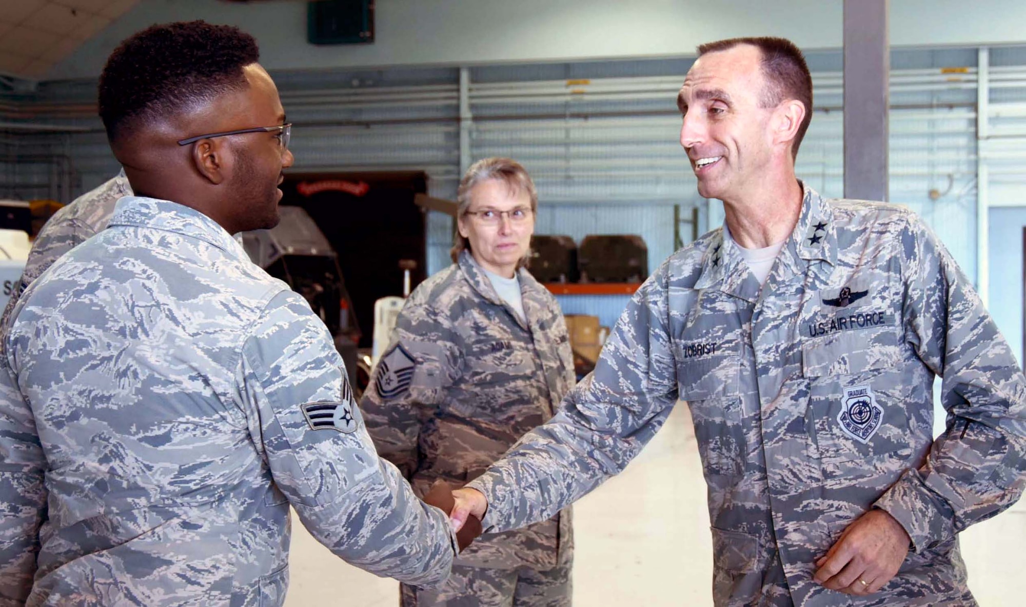 NAVAL AIR STATION FORT WORTH JOINT RESERVE BASE, Texas -- Maj. Gen. Scott Zobrist, 9th Air Force commander, coins Senior Airman Kevin Binion, a maintainer from the 355th Fighter Squadron, here for excellence in the performance of his duties, Mar. 2, 2017. The general visited and spoke with Airmen of the 355 FS, an active associate component of the 301st Fighter Wing, to get feedback about Total Force Integration, job performance and living conditions they experience. The 355 FS functions as a geographically separated unit under the 495th Fighter Group, 9th AF, Shaw Air Force Base, S.C. (U.S. Air Force photo by Tech. Sgt. Melissa Harvey)