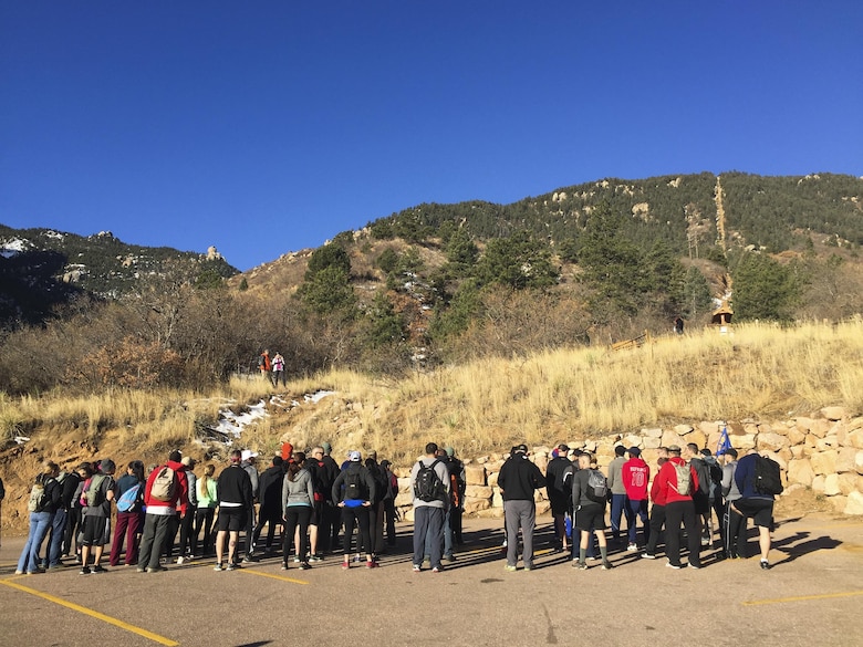 Defenders with the 50th Security Forces Squadron fall in formation for a safety briefing as well as words from squadron leadership prior to hiking the Incline at Manitou Springs, Colorado, Friday, March 3, 2017. The hiking event was held to honor Senior Airman Nicholas Alden, a fallen defender from 48th Security Forces Squadron at RAF Lakenheath. (U.S. Air Force photo/Tech. Sgt. Julius Delos Reyes)