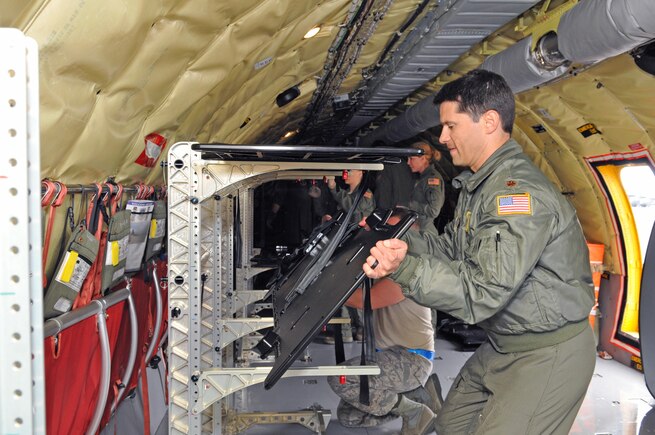 Maj. Phil Schembri, pilot with the 151st Air Refueling Squadron, assists medical personnel from the 375th Aeromedical Evacuation Squadron in reconfiguring a Utah Air Guard KC-135R Stratotanker to carry stretchers during an aeromedical evacuation mission on Feb. 18, 2017. (U.S. Air National Guard photo by Tech. Sgt. Annie Edwards)