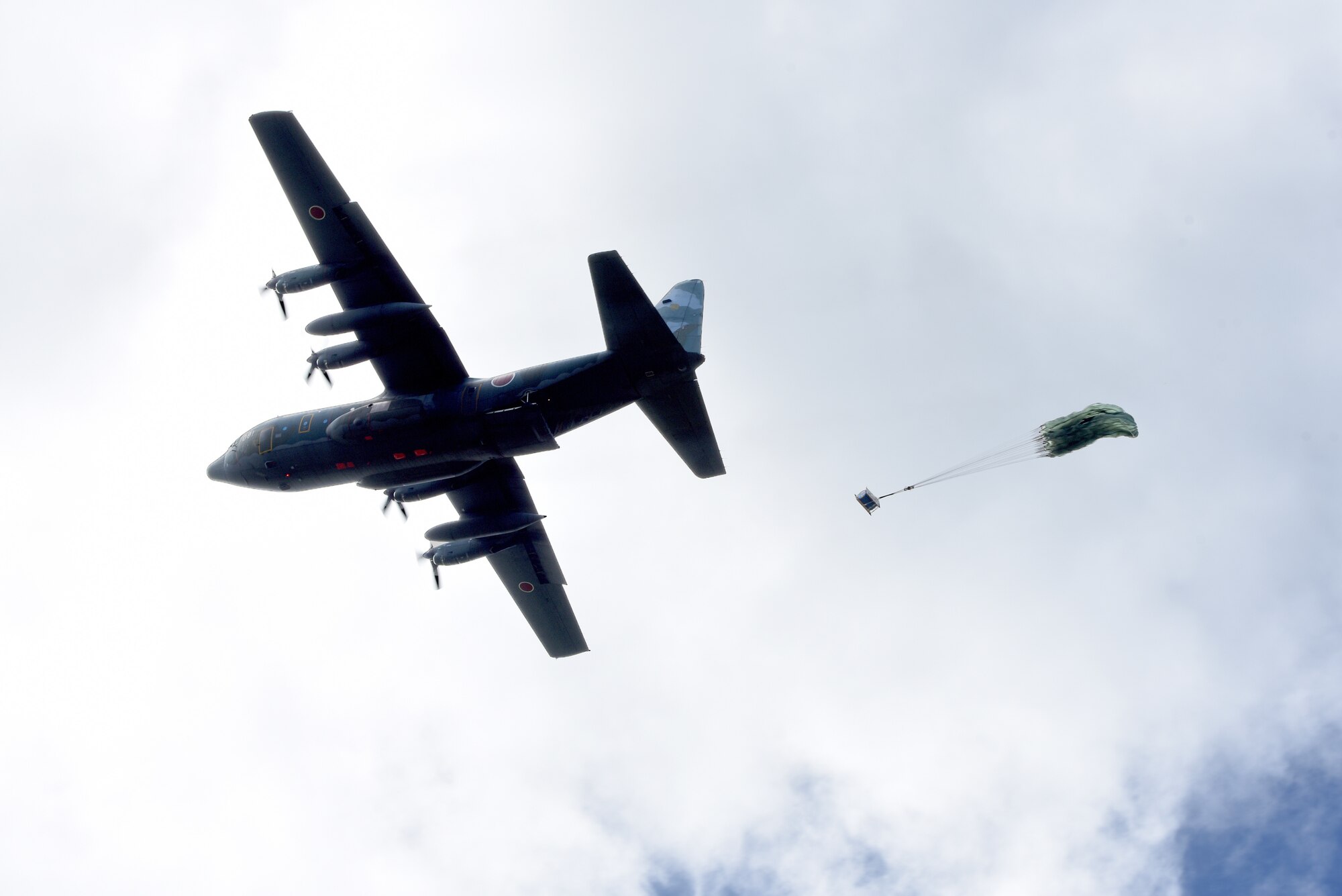 A Japan Air Self-Defense Force C-130 Hercules conducts for an airdrop during Exercise Cope North 17 at North Field, Tinian, Feb. 22, 2017. The exercise includes 22 total flying units and more than 2,700 personnel from three countries and continues the growth of strong, interoperable relationships within the Indo-Asia-Pacific region through integration of airborne and land-based command and control (U.S. Air Force photo by Airman 1st Class Jacob Skovo).
