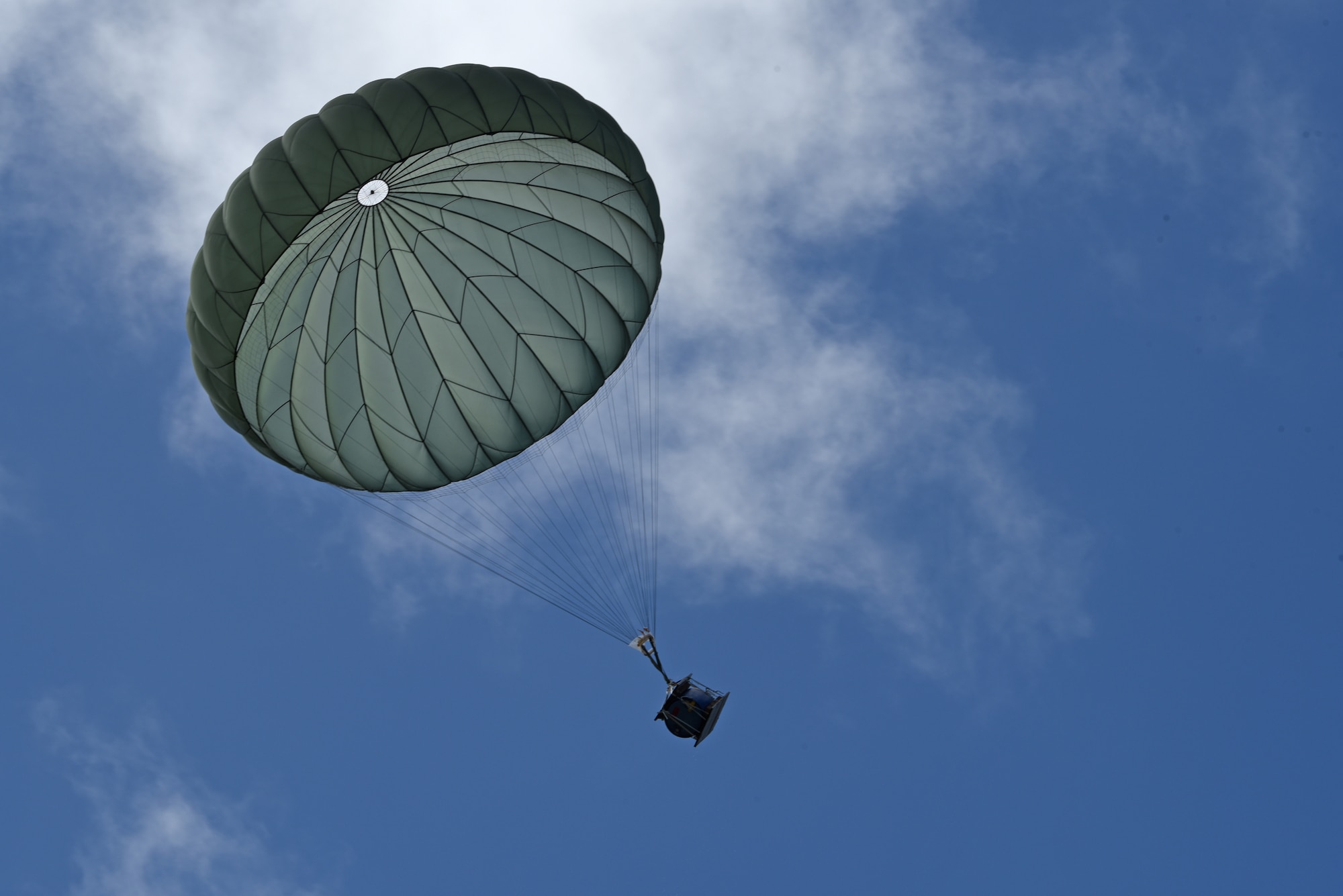 A water barrel falls after being airdropped by a Japan Air Self-Defense Force C-130 Hercules during Exercise Cope North 17 at North Field, Tinian, Feb. 22, 2017. The exercise includes 22 total flying units and more than 2,700 personnel from three countries and continues the growth of strong, interoperable relationships within the Indo-Asia-Pacific region through integration of airborne and land-based command and control (U.S. Air Force photo by Airman 1st Class Jacob Skovo).
