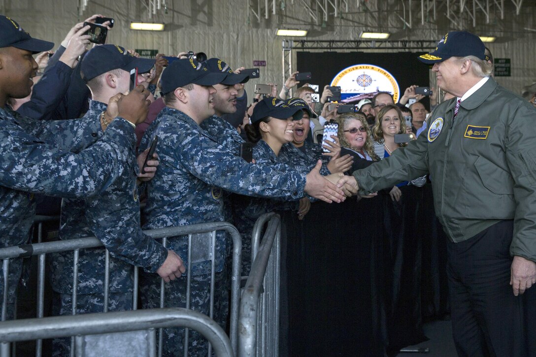 President Donald J. Trump greets sailors after entering the hangar bay aboard the future USS Gerald R. Ford in Newport News, Va., Mar. 2, 2017. Trump met with sailors and shipbuilders of the Navy’s newest aircraft carrier. Navy photo by Petty Officer 3rd Class Cathrine Mae O. Campbell