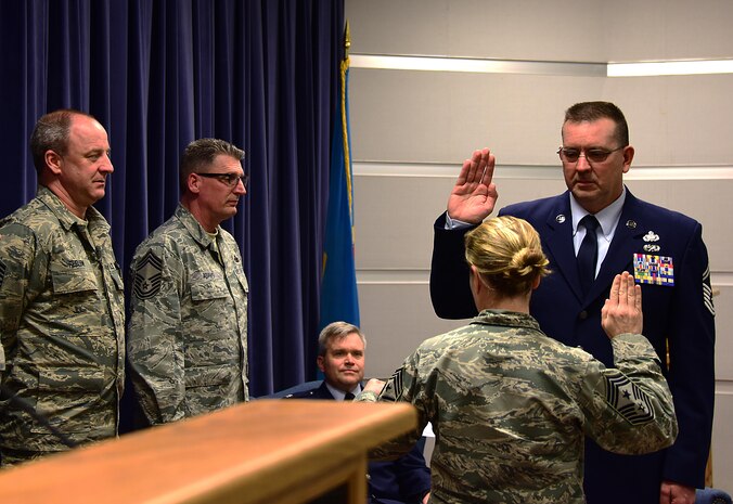 SMSgt. John Young, Supply Chief, 166th LRS, takes the chief’s oath from Command CMSgt. Shaune Peters, 166th Airlift Wing, during his promotion ceremony to Chief Master Sergeant, Delaware Air National Guard, New Castle, De., March 3, 2017. (U.S. Air National Guard photo by SSgt. Andrew Horgan/released)