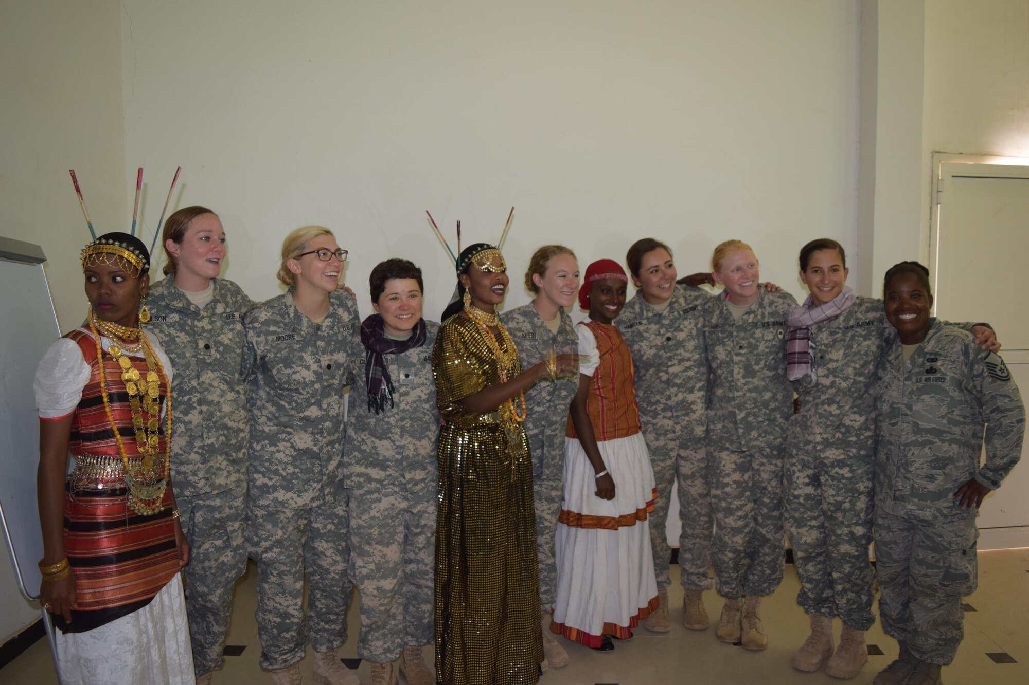 Master Sgt. Brittany Ingram, an Airman from the 123rd Airlift Wing Louisville, Kentucky, (far right) stands with a group of female U.S. Army Reserve Officer Corps cadets and three female cadets from the Djiboutian Army who are dressed in traditional Djiboutian clothing. Ingram chaperoned the group of Army ROTC cadets to Djibouti, Africa over the summer as a cadre member for the U.S. Army Command’s Cultural Language and Proficiency program. (Courtesy photo)