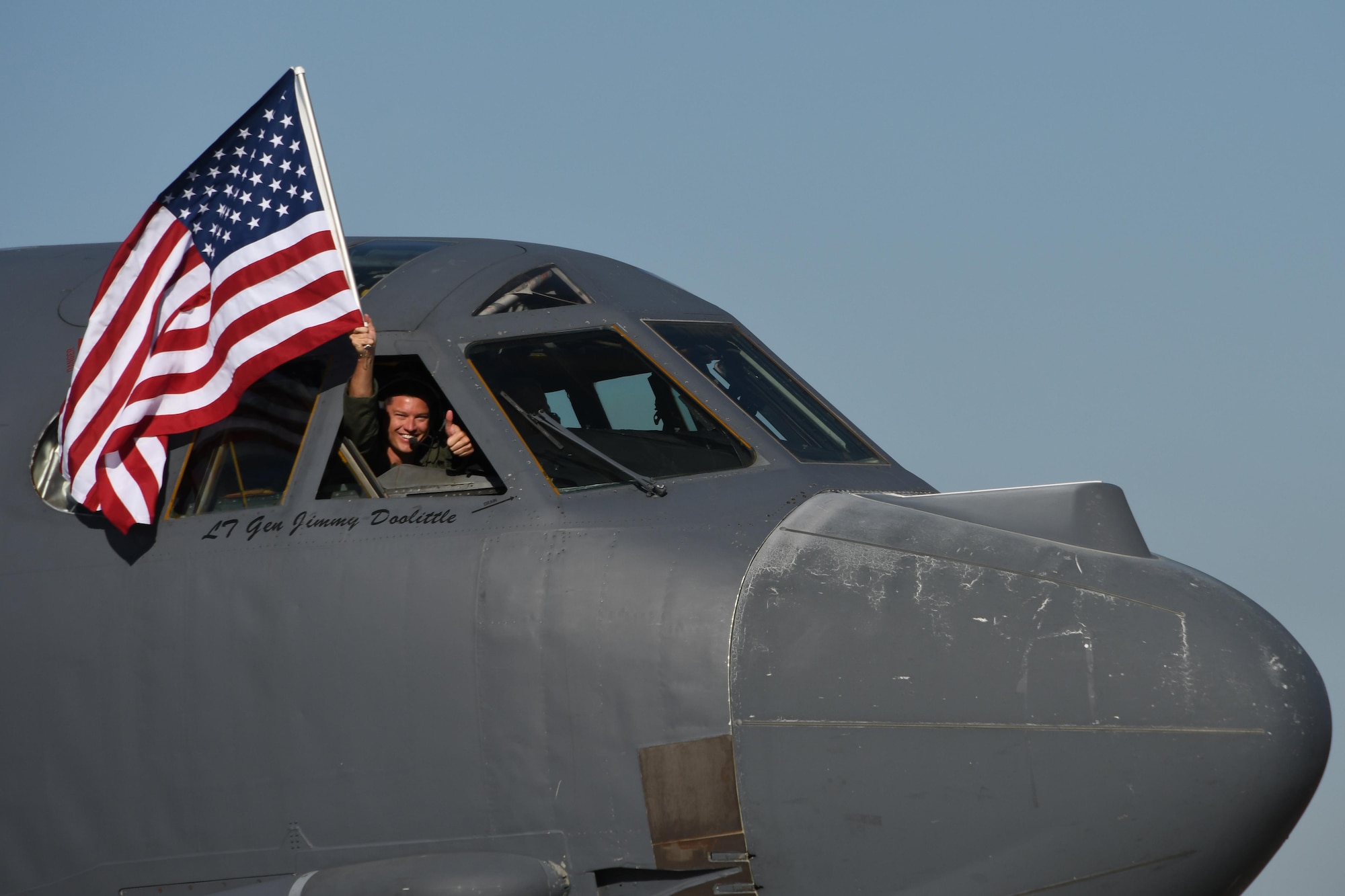 U.S. Air Force Lt. Col. Brent Weisner, 93rd Bomb Squadron commander waves the U.S. flag and gives a thumbs prior to takeoff at Barksdale Air Force Base, La., March 3, 2017.   The gestures by Weisner signified the historic nature of the flight which gave Lt. Col. Steve Smith, 93rd BS flight instructor, more than 10,000 flight hours in the B-52 Stratofortress. Smith has more hours in the B-52 than any other current member of the Air Force. (U.S. Air Force photo by Tech. Sgt. Ted Daigle/Released)