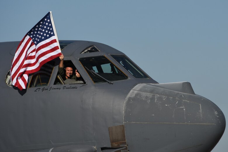 U.S. Air Force Lt. Col. Brent Weisner, 93rd Bomb Squadron commander waves the U.S. flag and gives a thumbs prior to takeoff at Barksdale Air Force Base, La., March 3, 2017.   The gestures by Weisner signified the historic nature of the flight which gave Lt. Col. Steve Smith, 93rd BS flight instructor, more than 10,000 flight hours in the B-52 Stratofortress. Smith has more hours in the B-52 than any other current member of the Air Force. (U.S. Air Force photo by Tech. Sgt. Ted Daigle/Released)