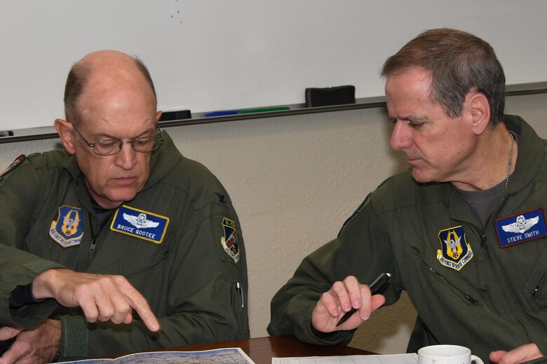 U.S. Air Force Col. Bruce Gootee, 307th Bomb Wing navigator and Lt. Col. Steve Smith, 93rd Bomb Squadron flight instructor, review a map during an early morning mission briefing at Barksdale Air Force Base, La., March 3, 2017.  The routine training mission took on great significance as it put Smith over 10,000 flight hours in the B-52 Stratofortress, a feat not accomplished in more than 30 years. (U.S. Air Force photo by Tech. Sgt. Ted Daigle/Released)