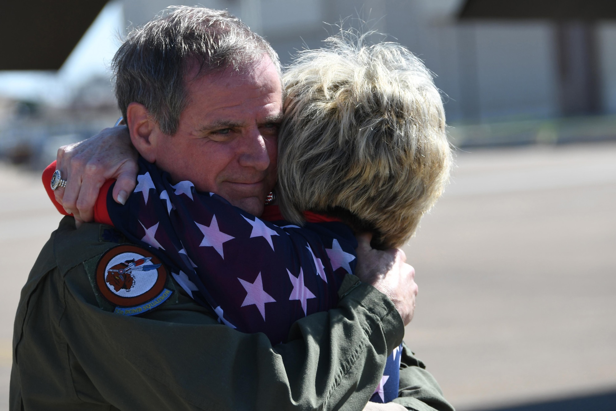 U.S. Air Force Lt. Col. Steve Smith hugs his wife, Jayne, after returning from a training mission at Barksdale Air Force, La., March 3, 2017. During the mission, Smith surpassed 10,000 flight hours in the B-52 Stratofortress. He is a veteran of 1,800 missions and multiple combat deployments. (U.S. Air Force photo by Tech. Sgt. Ted Daigle/Released)