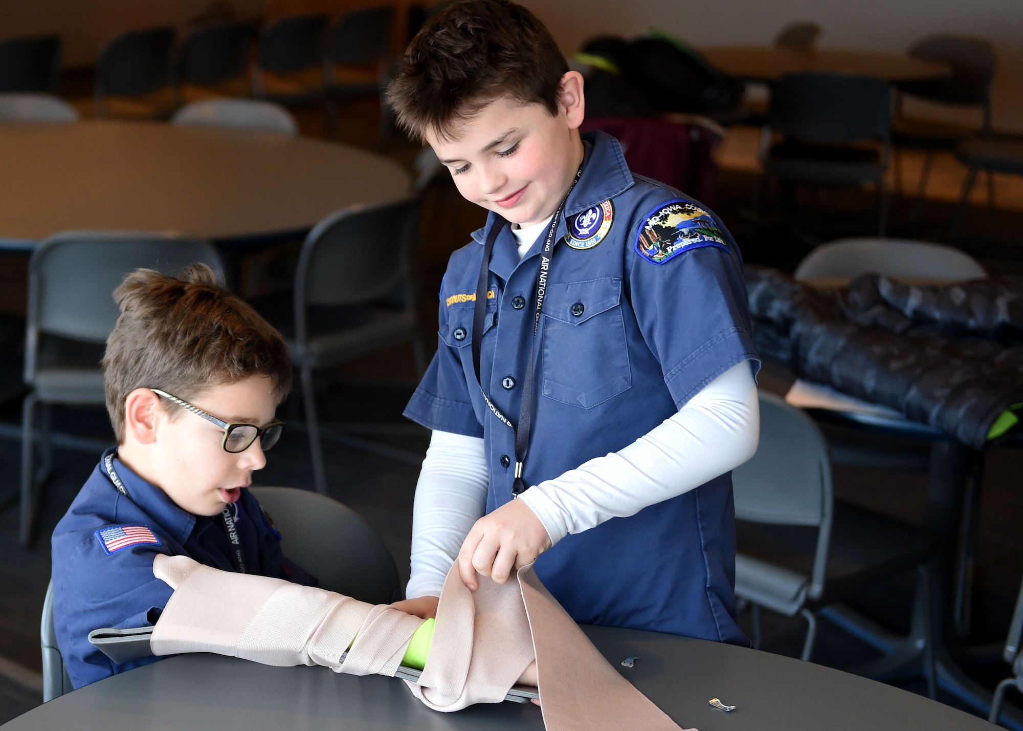 Two Cub Scouts practice splinting a broken arm March 4, 2017, in the Wing Classroom at the Des Moines Airbase, Iowa. Scouts from Iowa Pack 95 toured the base, learned about the Wing's missions and recieved safety demonstrations. (U.S. Air National Guard photo by Staff Sgt. Michael J. Kelly)