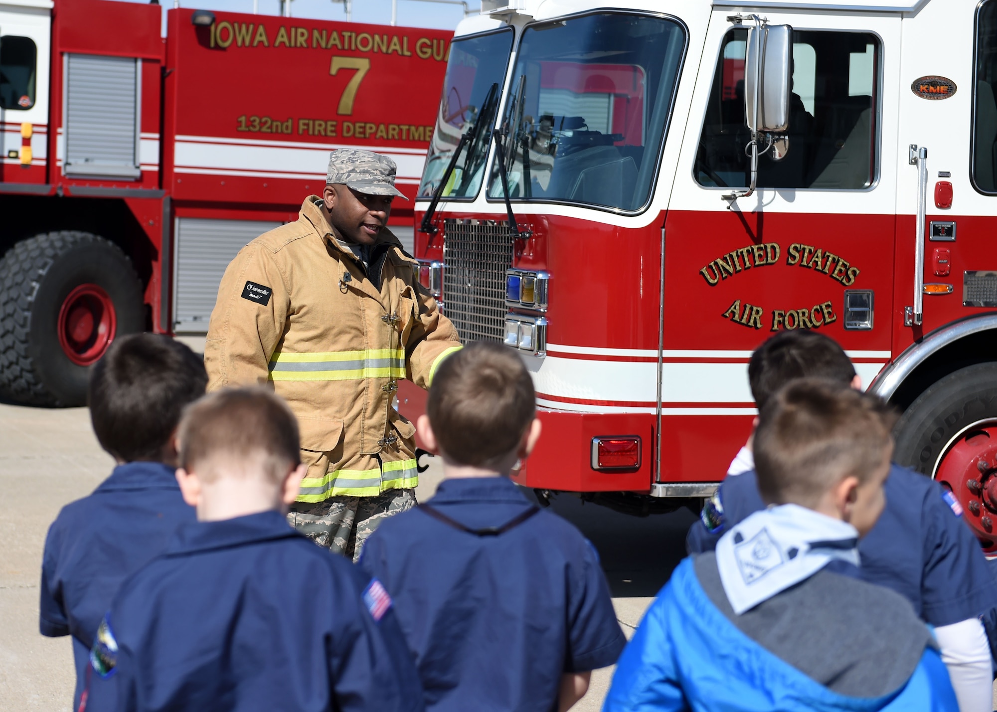 Senior Airman Eric Tate, 132d Fire Emergence Services, shows off a firetruck to visiting Cub Scouts, March 4, 2017, at the Des Moines Airbase, Iowa. Scouts from Iowa Pack 95 toured the base, learned about the Wing's missions and recieved safety demonstrations. (U.S. Air National Guard photo by Staff Sgt. Michael J. Kelly)