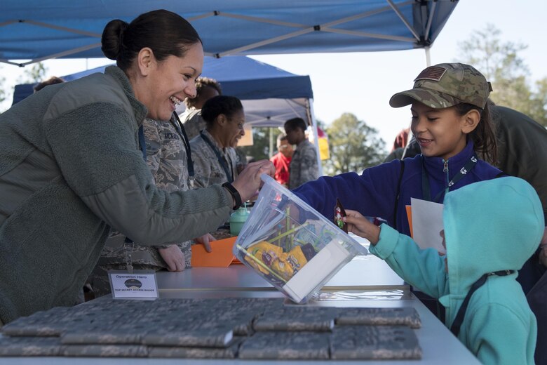 New 919th Special Operations Wing deployers grab a treat before their mission during the Operation Hero event at Duke Field, Fla., March 4.  The wing held a mock deployment for the Reserve children to include a deployment line, simulated flight and a “down range” location with games and displays.  (U.S. Air Force photo/Samuel King Jr.)