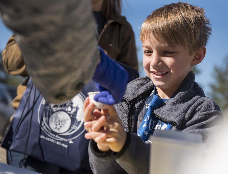 A new 919th Special Operations Wing deployer receives some “medicine” prior to their mission during the Operation Hero event at Duke Field, Fla., March 4.  The wing held a mock deployment for the Reserve children to include a deployment line, simulated flight and a “down range” location with games and displays.  (U.S. Air Force photo/Samuel King Jr.)