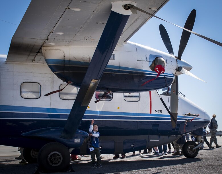 A new 919th Special Operations Wing deployer marvels at C-145A Skytruck during the Operation Hero event at Duke Field, Fla., March 4.  The wing held a mock deployment for the Reserve children to include a deployment line, simulated flight and a “down range” location with games and displays.  (U.S. Air Force photo/Samuel King Jr.)