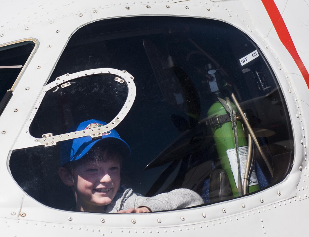 A new 919th Special Operations Wing deployer checks out the view from the pilot seat of a C-145A Skytruck during the Operation Hero event at Duke Field, Fla., March 4.  The wing held a mock deployment for the Reserve children to include a deployment line, simulated flight and a “down range” location with games and displays.  (U.S. Air Force photo/Samuel King Jr.)